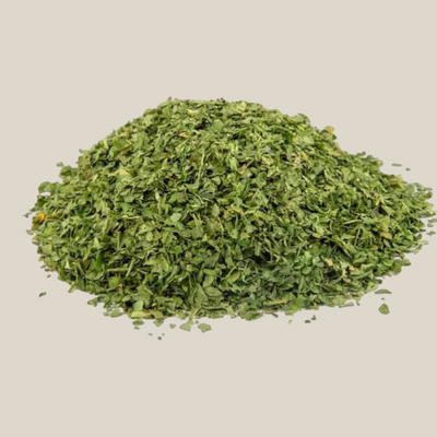 TuanaShop BV gesneden peterselie van 4mm in een hoopje, gedroogd groen kruid voor soepen en sauzen.