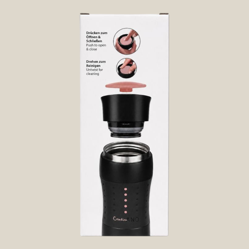 TuanaShop BV Creano travel mug in zwarte verpakking met instructies voor de drukknop en reiniging van de deksel