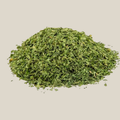 TuanaShop BV gesneden peterselie van 4mm in een hoopje, gedroogd groen kruid voor soepen en sauzen.